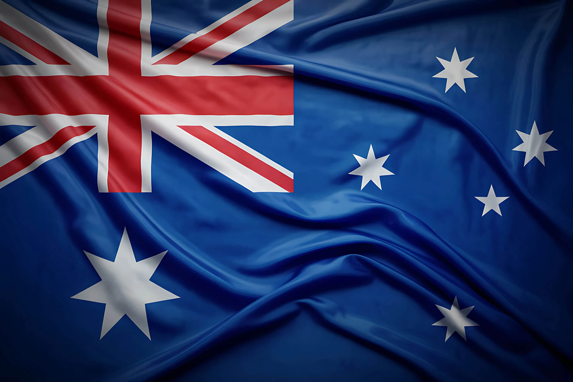 The image shows the flag of Australia, featuring the Union Jack in the top left corner, a large white seven-pointed star below it, and five white stars on the right side against a blue background.